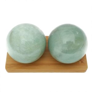 Green aventurine baoding balls on a display stand