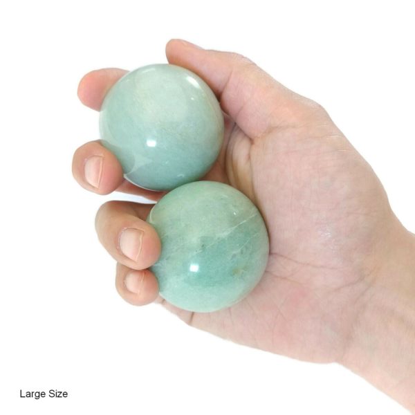 Hand holding large aventurine baoding balls