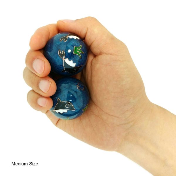 Hand holding medium dolphin baoding balls