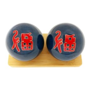 Good fortune baoding balls on a display stand