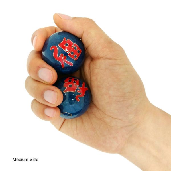Hand holding medium good fortune baoding balls
