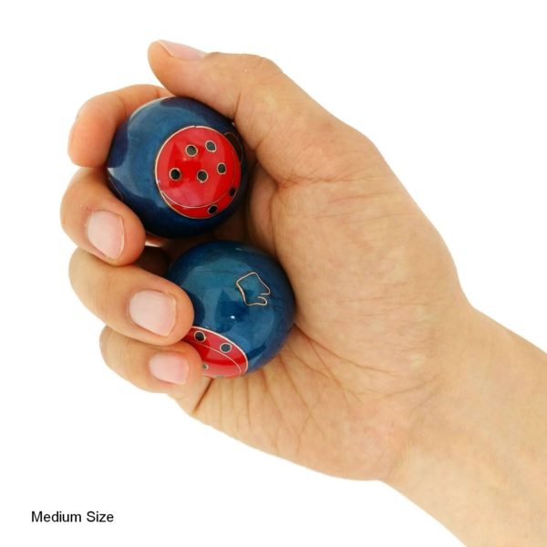Hand holding medium ladybug baoding balls