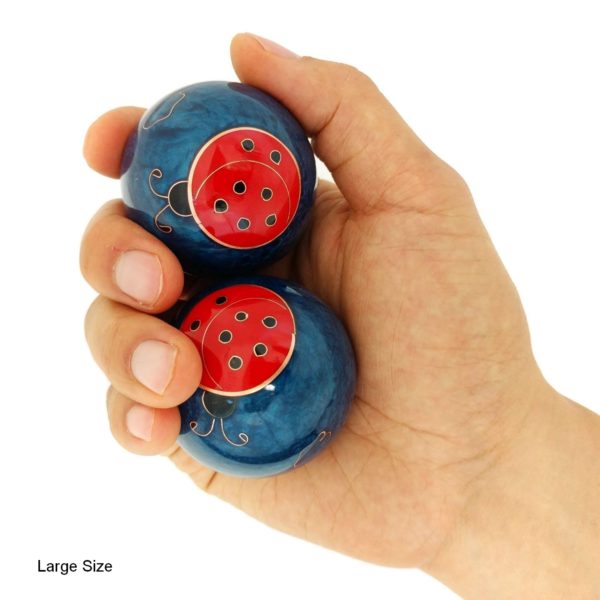Hand holding large ladybug baoding balls