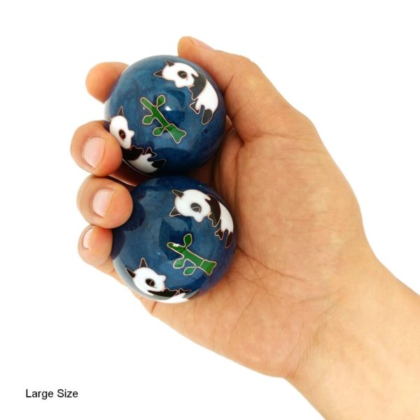 Hand holding large panda baoding balls