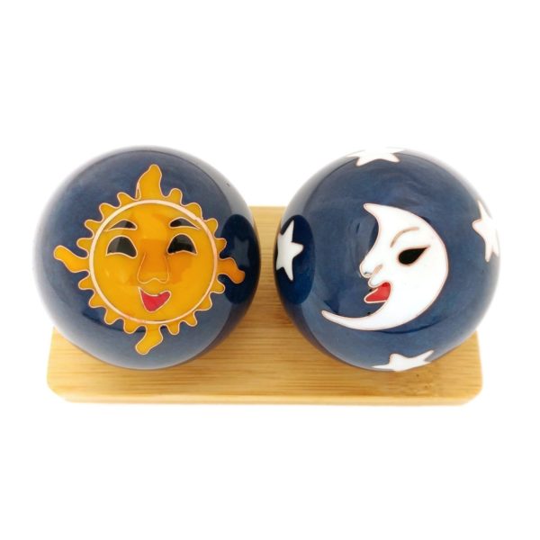 Sun and moon baoding balls on a display stand