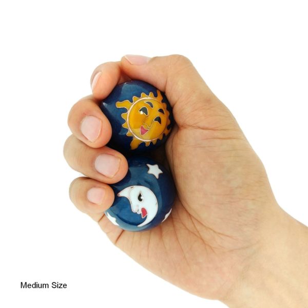 Hand holding medium sun and moon baoding balls