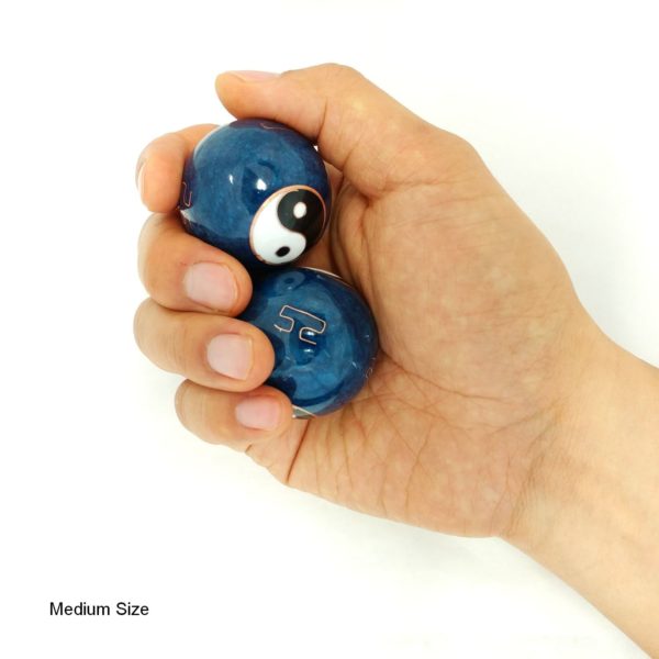 Hand holding medium yin yang baoding balls