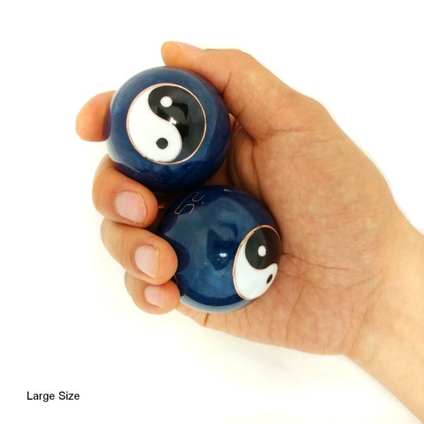 Hand holding large yin yang baoding balls