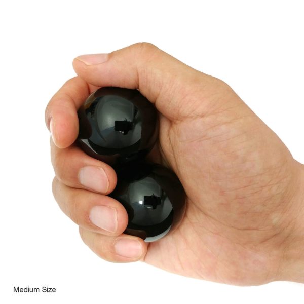 Hand holding black obsidian baoding balls