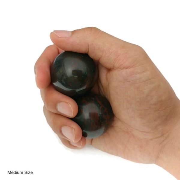 Hand holding medium bloodstone baoding balls