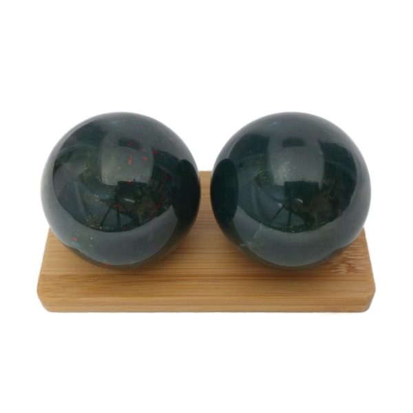 Bloodstone baoding balls on a display stand