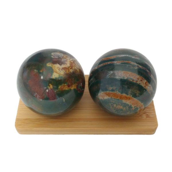 Bloodstone baoding balls on a display stand