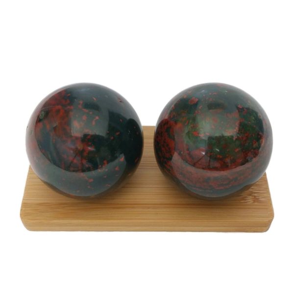 Bloodstone baoding balls on a display stand