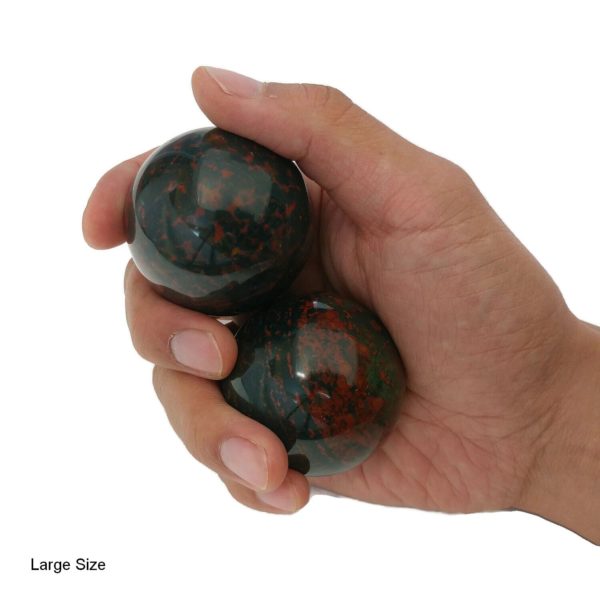 Hand holding bloodstone baoding balls