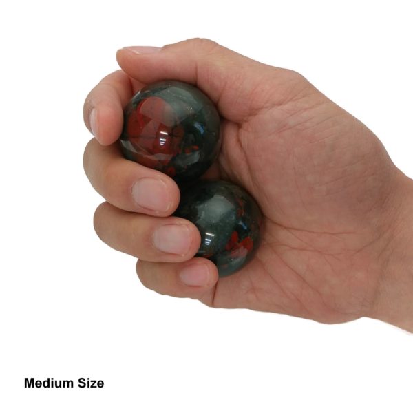 Hand holding bloodstone baoding balls