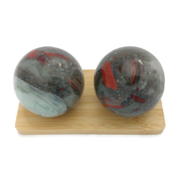 Bloodstone baoding balls on a display stand