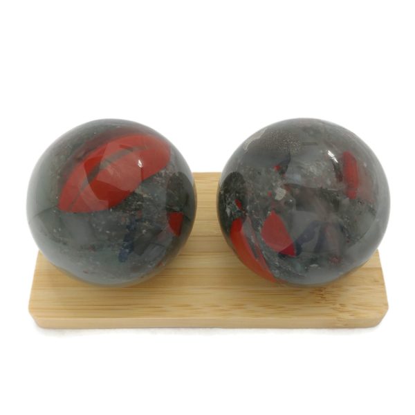 Bloodstone baoding balls on a display stand