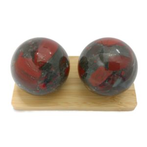 Bloodstone baoding balls on a display stand