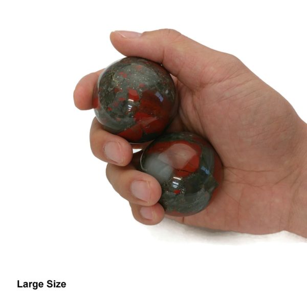 Hand holding bloodstone baoding balls