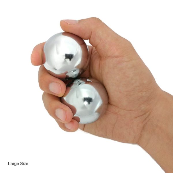 Hand holding large chrome baoding balls