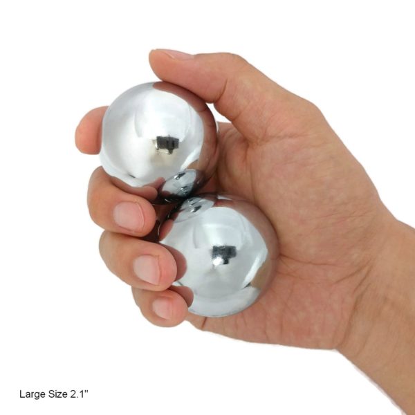 Hand holding large chrome baoding balls