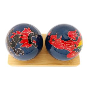 Dragon and Phoenix baoding balls on a display stand