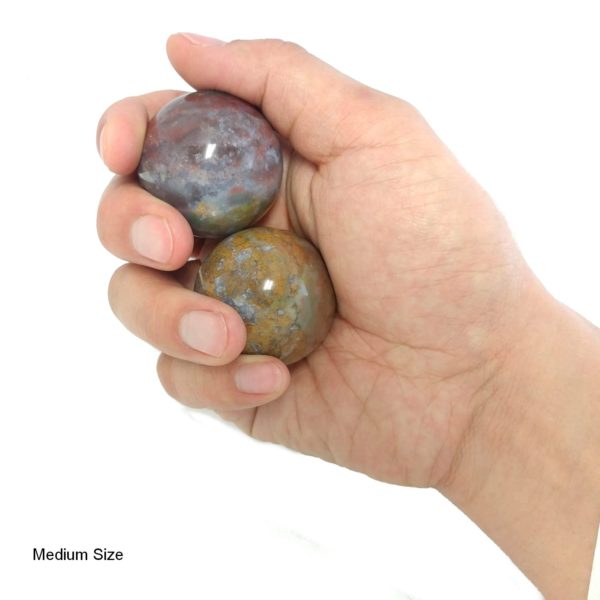 Hand holding medium sized fancy jasper baoding balls