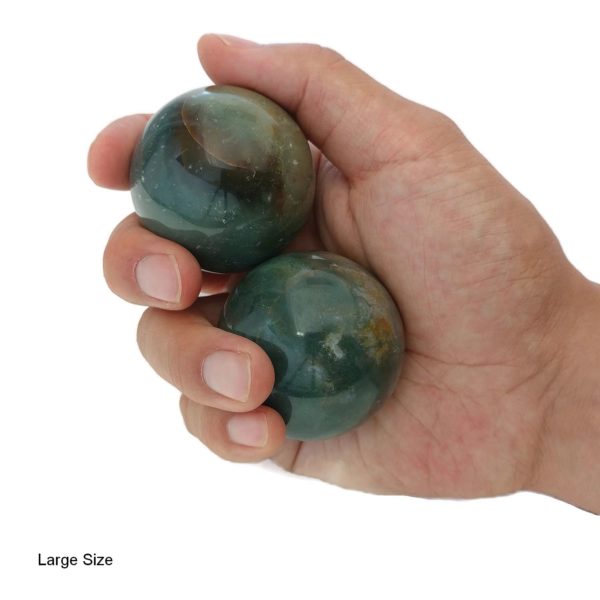 Hand holding large fancy jasper baoding balls