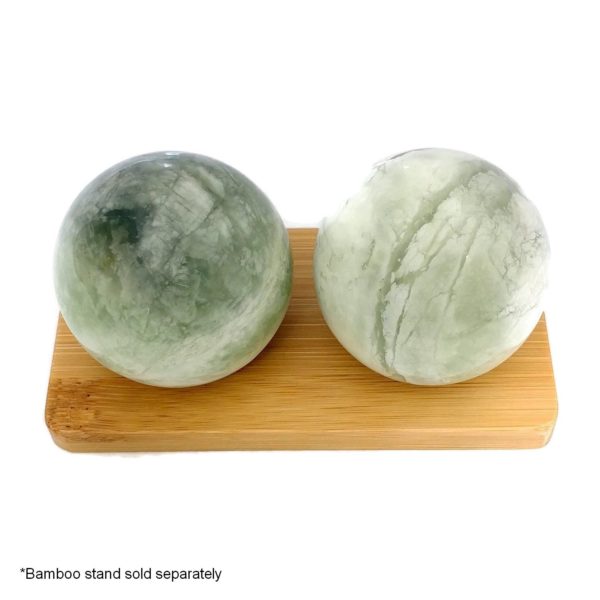 Green jade baoding balls on bamboo display stand