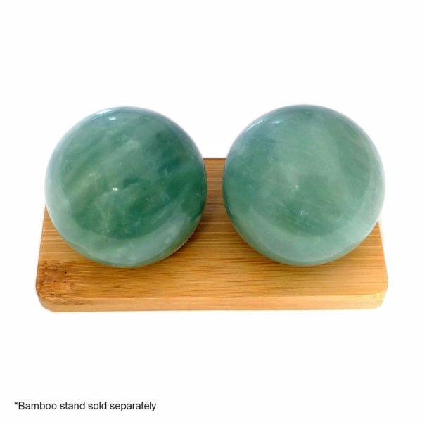 Green jade baoding balls on bamboo display stand