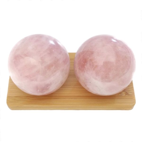 Rose quartz baoding balls on a display stand
