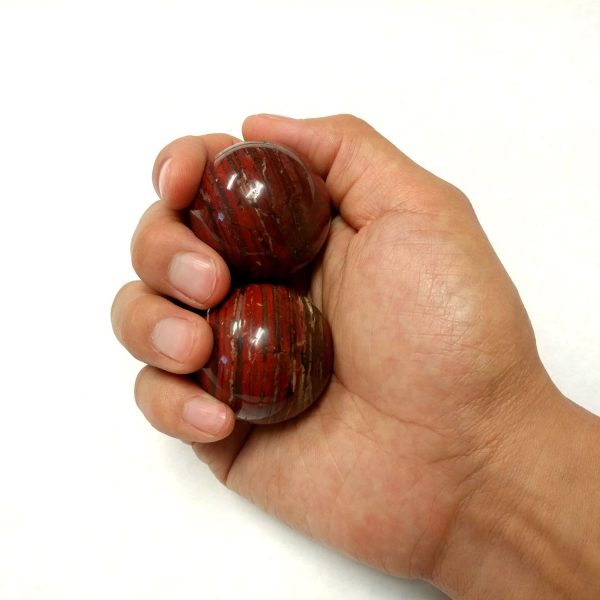 Hand holding medium snakeskin jasper baoding balls