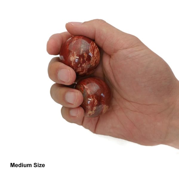 Hand holding medium sized snakeskin jasper baoding balls