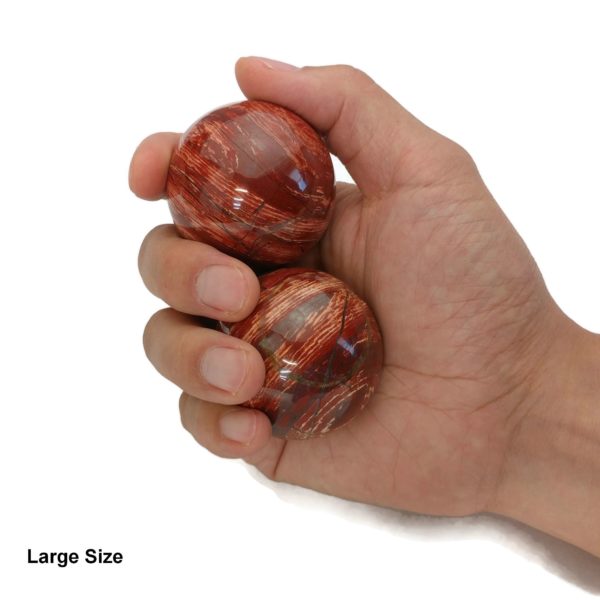 Hand holding large sized snakeskin jasper baoding balls