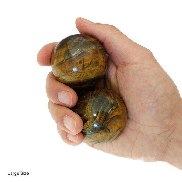 Hand holding large tiger eye baoding balls