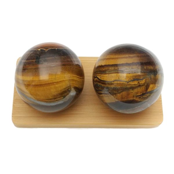 Tigers eye baoding balls on a display stand