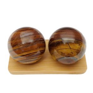 Tiger iron baoding balls on a bamboo display stand