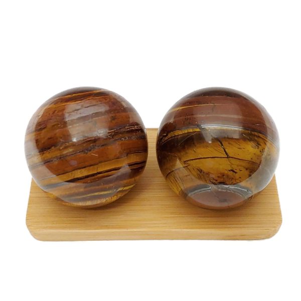 Tiger iron baoding balls on a bamboo display stand