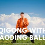 Man doing qigong with text Qigong with Baoding Balls