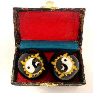 Black baoding balls with sun and moon yin yang design in a box