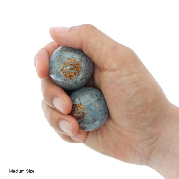 Hand holding angelite orgonite baoding balls