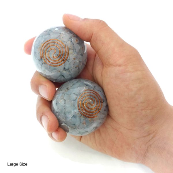 Hand holding angelite orgonite baoding balls