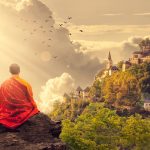 Monk meditating on a mountain