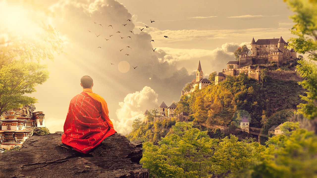 Monk meditating on a mountain