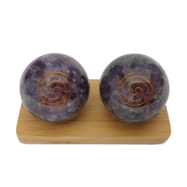 Amethyst orgonite baoding balls on a display stand