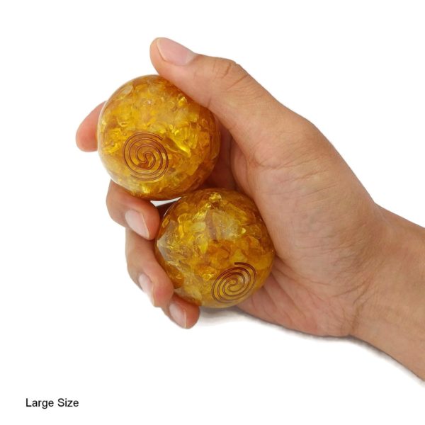 Hand holding citrine quartz baoding balls
