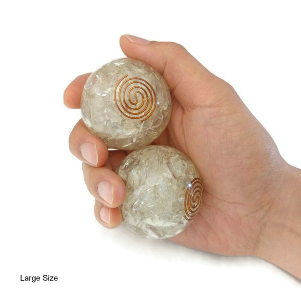 Hand holding 2 large quartz orgonite baoding balls