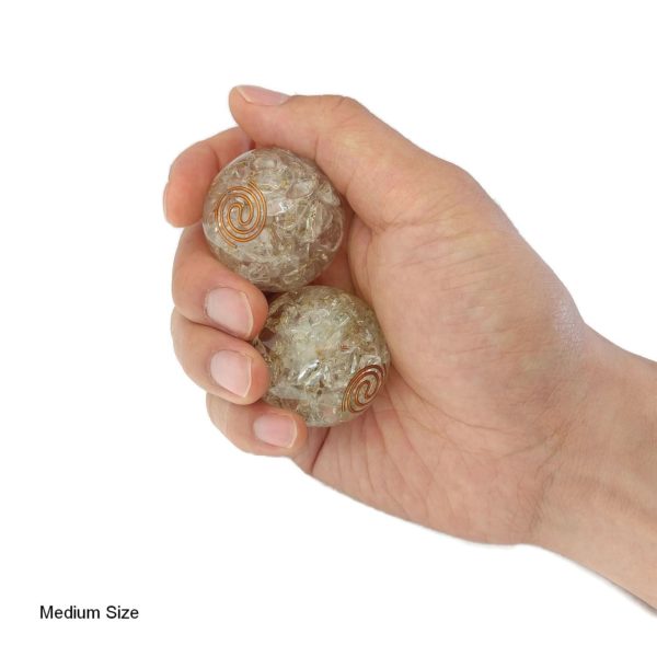 Hand holding 2 medium quartz orgonite baoding balls
