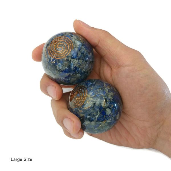 Hand holding lapis lazuli orgonite baoding balls
