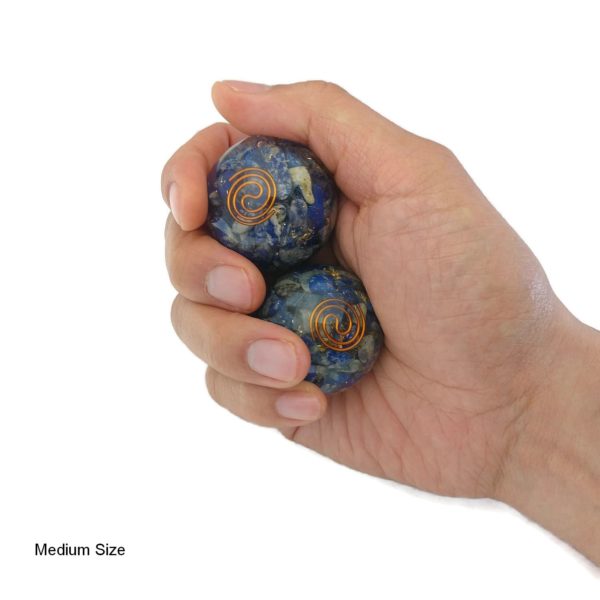 Hand holding lapis lazuli orgonite baoding balls